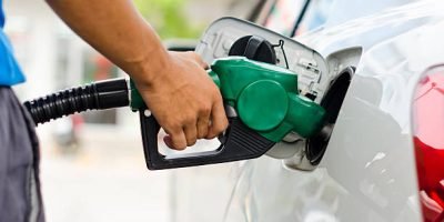 Refueling Car With Gasoline Pump Nozzle, Selective Focus on pump nozzle